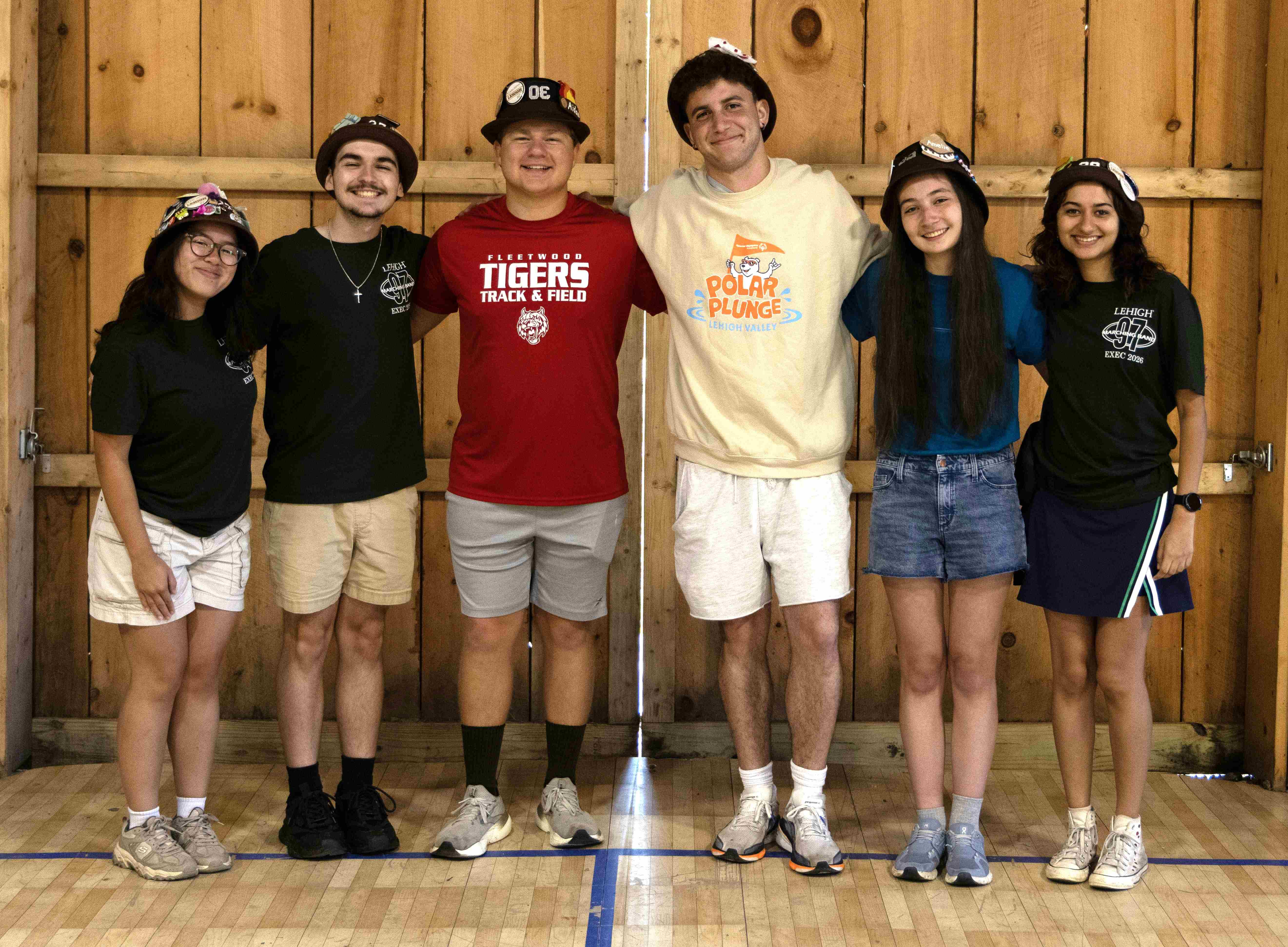 Rank 11 smiling with their arms around each other at band camp.